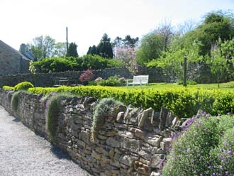 Dry stone walls surround the lawn area