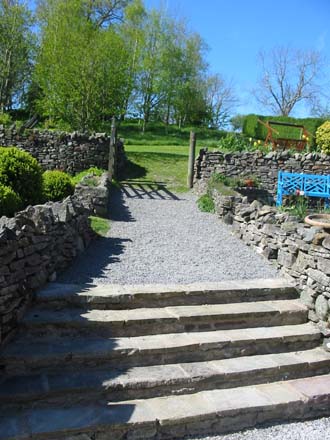 Stone steps leading through to the woodland copse