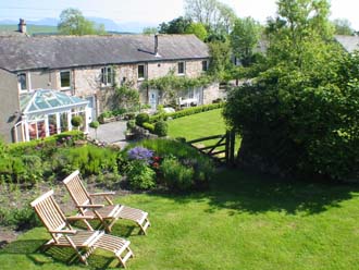 Dry border viewed directly towards Huddlestone Cottage and The Hayloft