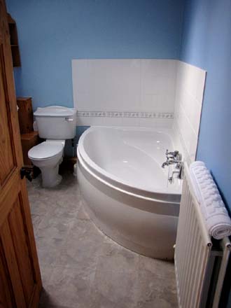 Upstairs bathroom with corner bath