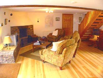 Huddlestone Cottage living room with open log fire