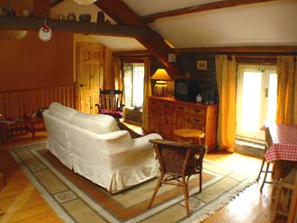 View across living room towards the entrance stairs